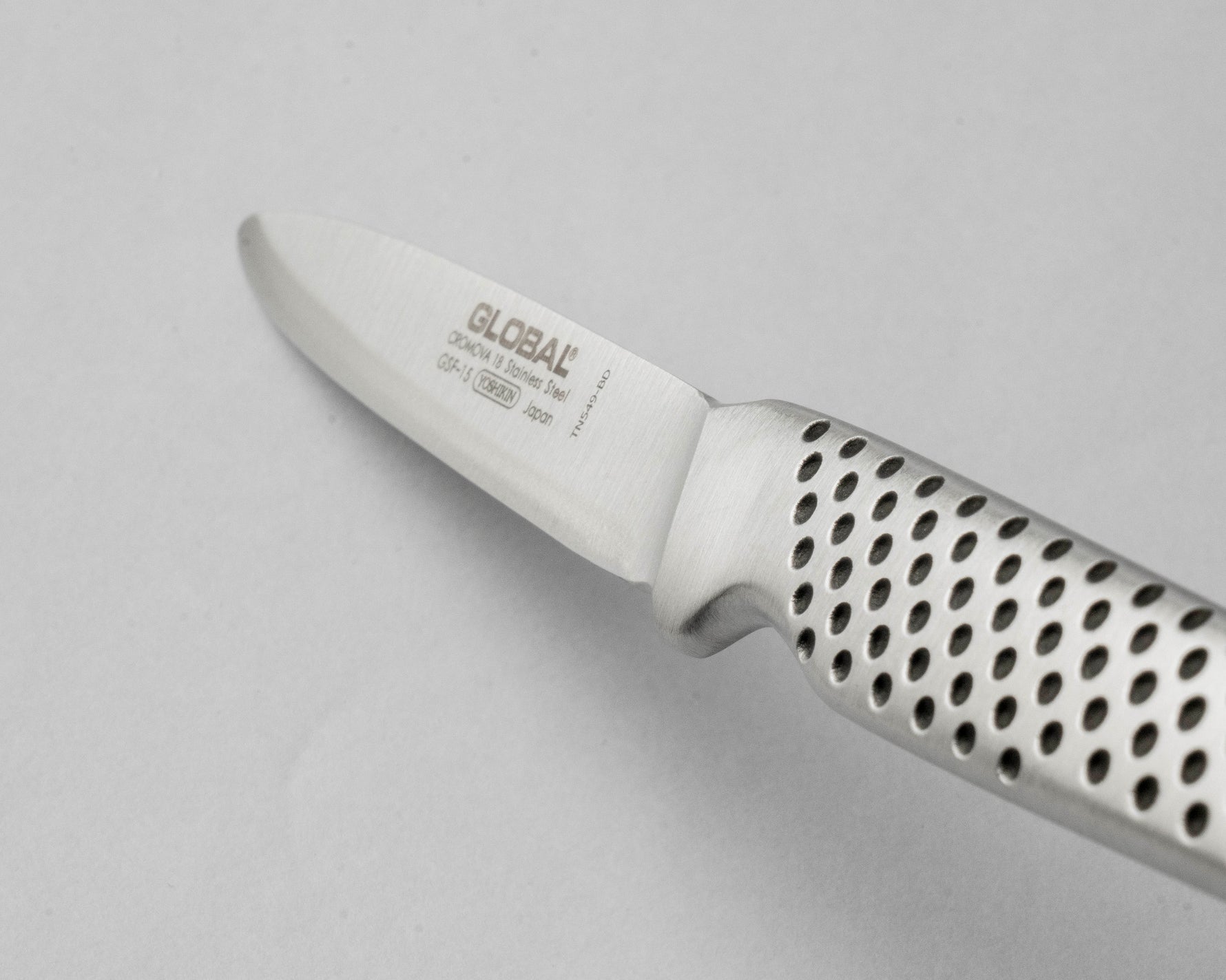 Stainless steel Peeling knife with perforated handle on a light gray background, the GSF-15
