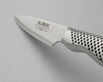 Close-up of a Global small utility knife on a gray background