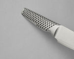 Close up of GSF-46 paring knife with a perforated handle on a grey background