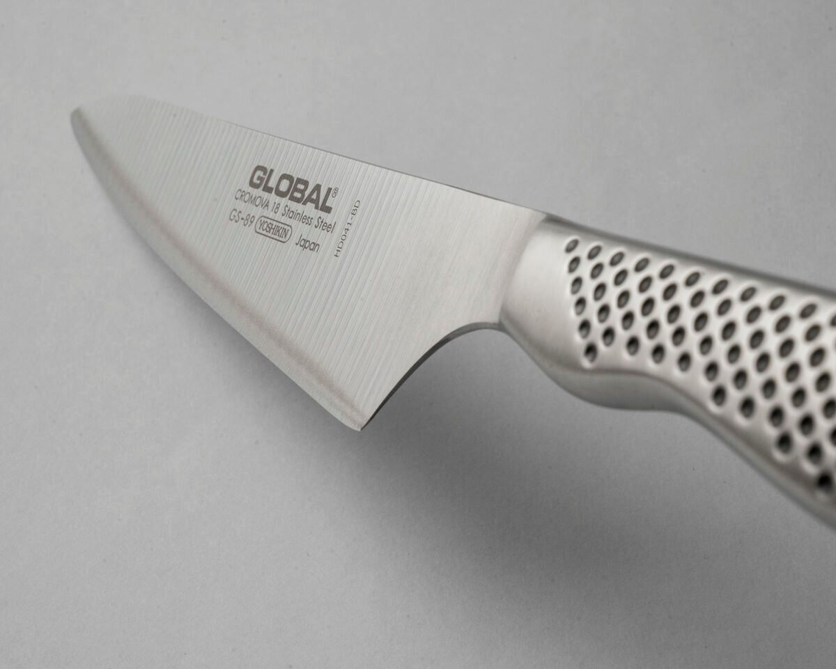 Global GS-89 Cook's Knife with a stainless steel blade and a textured, perforated silver handle, shown on a neutral grey background.