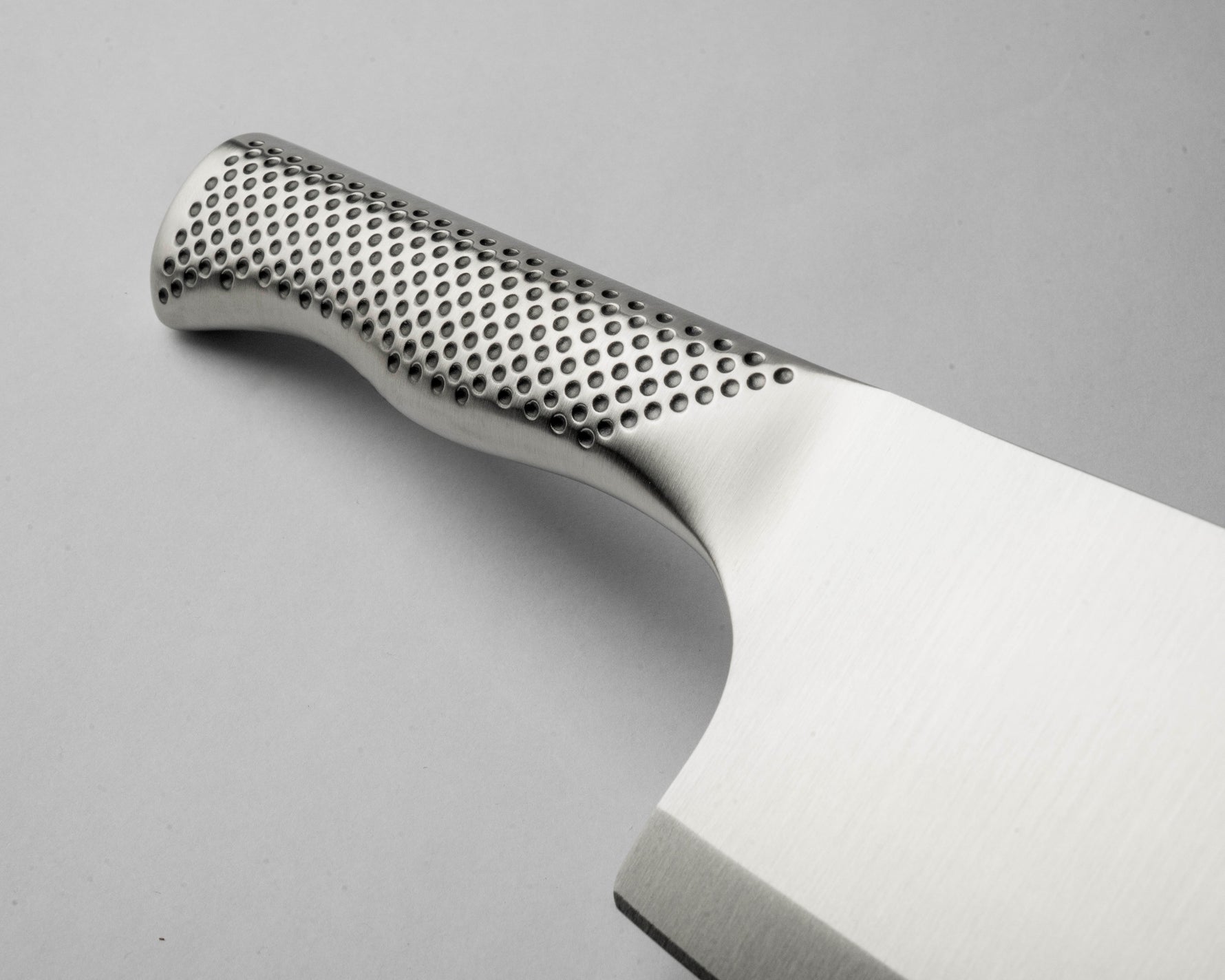 Close up of G-12 Meat Chopper's handle showing indentations for grip and ergonomic design.