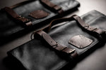 2 black leather knife roll cases with 5-slot and 10-slot capacity