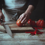 Professional chef using Global G-2 Cook's knife for slicing tomatoes. Ultra sharp kitchen knife for effortless slicing, cutting and dicing.